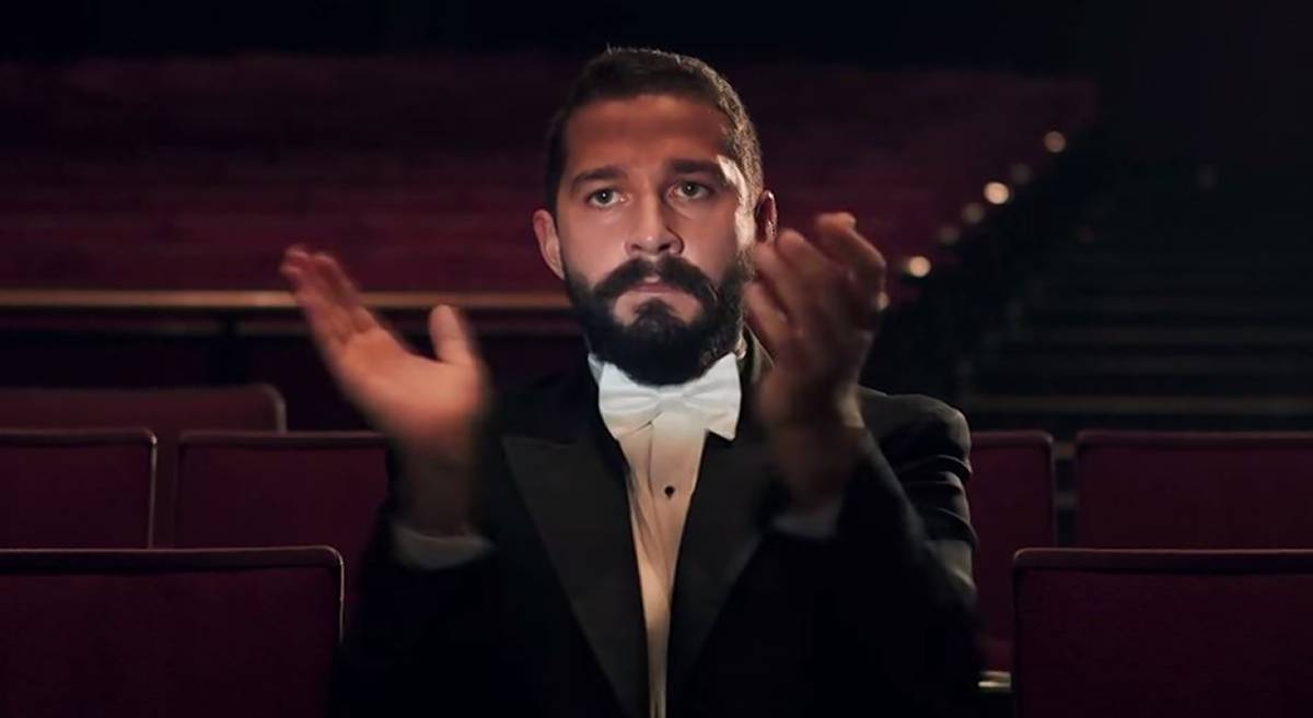 Shia LaBeouf in a tuxedo clapping.